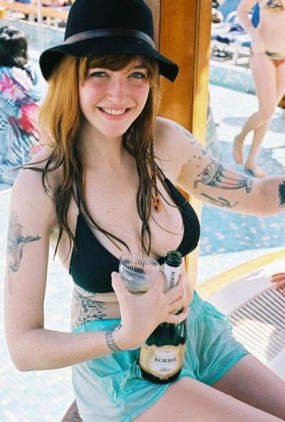 Big tittied tattooed girl having a drink
