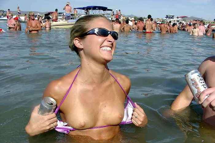 Cute blonde teen exposing her small tits in the lake
