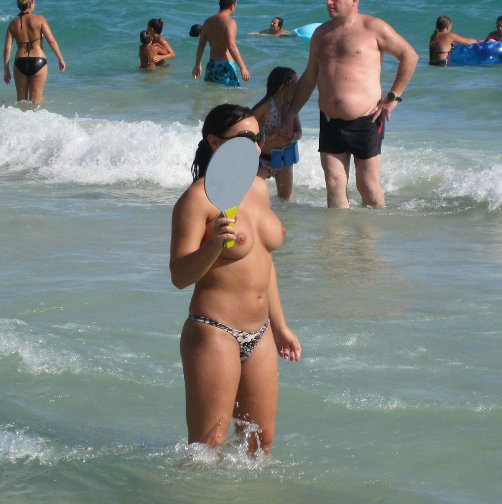 Perky titted topless woman in ocean