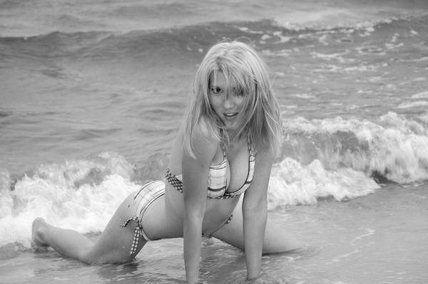 Flirty girl posing playfully in the sea