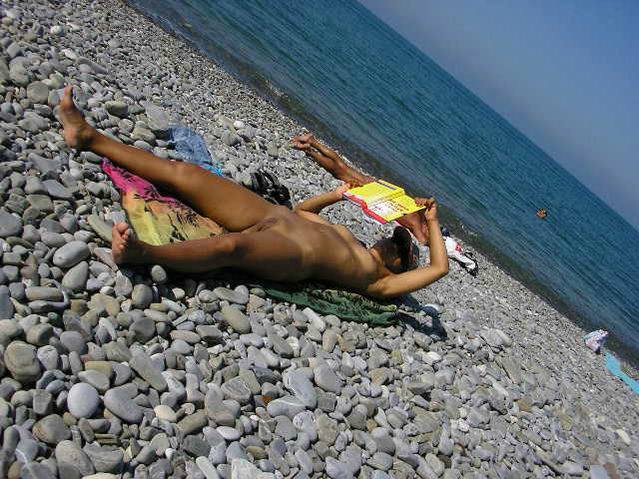 Naked hottie enjoying some summer reading