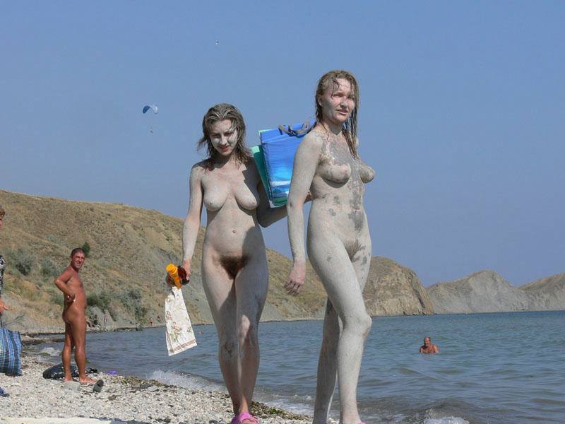 Nude muddy teens walking on the beach