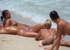 Topless babes resting on the seashore